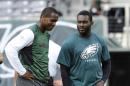 FILE - In this Aug. 29, 2013, file photo, New York Jets quarterback Geno Smith, left, talks to Philadelphia Eagles quarterback Michael Vick before a preseason NFL football game in East Rutherford, N.J. The Jets signed the former Philadelphia Eagles quarterback to a one-year deal Friday, March 21, 2014, and released Mark Sanchez, the one-time face of the franchise. (AP Photo/Bill Kostroun, File)
