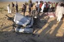 People check the scene where a car bomb exploded in near the port town of El-Arish in Egypt's Sinai peninsula