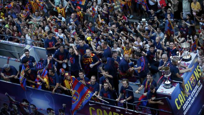 Barcelona&#39;s players celebrate from an open-top bus during celebration parade in Barcelona