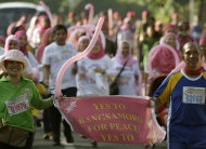 Filipino Muslims and members of the Philippine military join a fun run in support of a preliminary peace agreement between the government and the nation's largest Muslim rebel group in suburban Quezon city, north of Manila, Philippines on Sunday Oct. 14, 2012. Philippine officials hope a preliminary peace deal the government recently clinched with the Moro Islamic Liberation Front will eventually turn the 11,000-strong insurgent group into a formidable force against the remnants of the Abu Sayyaf and other radicals, including several Indonesian and Malaysian militants believed to be taking cover in the southern Mindanao region.(AP Photo/Aaron Favila)