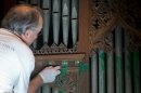 William Adair of Gold Leaf Studios remove green paint from the organ in the Washington National Cathedral's historic Bethlehem Chapel, Tuesday, July 30, 2013, in Washington. Officials at the cathedral discovered the paint inside two chapels Monday afternoon. The paint was splashed onto the organ and on the floor inside the Bethlehem Chapel on the basement level and inside Children's Chapel in the nave of the cathedral. (AP Photo/Carolyn Kaster)