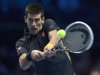 Serbia's Djokovic hits a return to Britain's Murray during their men's singles tennis match at the ATP World Tour Finals in London