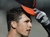 San Francisco Giants' Buster Posey removes his cap during batting practice before an exhibition spring training baseball game against the Oakland Athletics, Thursday, March 28, 2013, in San Francisco. (AP Photo/Ben Margot)
