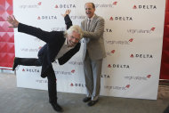 Virgin CEO Richard Branson, left, and Delta airlines CEO Richard Anderson pose for photographers inside the new Delta terminal 4 at JFK airport, Friday, May 24, 2013 in New York. Delta opened its new $1.4 billion terminal, strengthening its hand in the battle for the lucrative New York travel market. The expanded concourse offers sweeping views of the airport, upscale food and shopping options and increased seating. It replaces a decrepit terminal built by Pan Am in 1960 that was an embarrassing way to welcome millions of visitors to the United States. (AP Photo/Mary Altaffer)