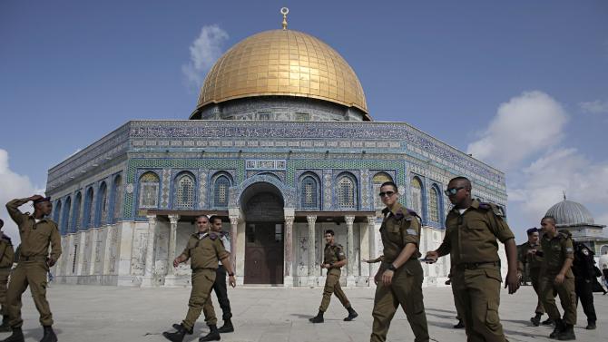 Israeli soldiers walk in front of the Dome of the Rock in the Al-Aqsa mosque compound, in Jerusalem's old city on October 19, 2014