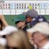 Spectators walk past a leader board displaying Tiger Woods' two first two rounds scores before the third round of the Masters golf tournament Saturday, April 13, 2013, in Augusta, Ga. The score board reflects the 2-stroke penalty assessed to Woods for a drop in 2nd round of the Masters. (AP Photo/Matt Slocum)