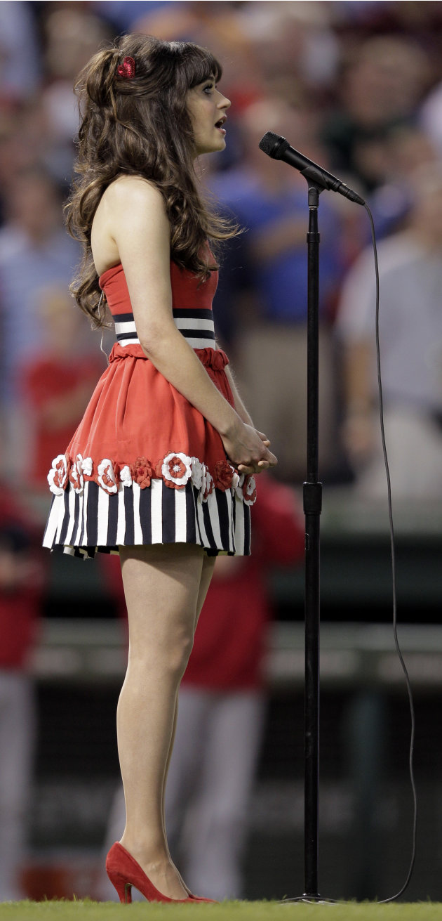 Zooey Deschanel sings the national anthem before Game 4 of baseball's World Series  between the St. Louis Cardinals and Texas Rangers Sunday, Oct. 23, 2011, in Arlington, Texas. (AP Photo/Charlie Ried