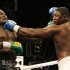 James Toney grimaces as Samuel Peter of Nigeria punches him during WBC Heavyweight Boxing Championship elimination bout in Hollywood
