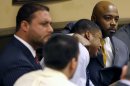 Defense attorney Walter Madison, right, holds his client, 16-year-old Ma'Lik Richmond, second from right, while defense attorney Adam Nemann, left, sits with his client Trent Mays, foreground, 17, as Judge Thomas Lipps pronounces them both delinquent on rape and other charges after their trial in juvenile court in Steubenville, Ohio, Sunday, March 17, 2013. Mays and Richmond were accused of raping a 16-year-old West Virginia girl in August 2012. (AP Photo/Keith Srakocic, Pool)