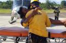 In this photo distributed by Colombia's Air Force, a rescue worker puts Maria Nelly Murillo on a stretcher after she and her baby were airlifted for medical treatment to Quibdo, in Colombia's western state of Choco, Wednesday, June 24, 2015. Rescuers reached Murillo and her 1-year-old son after they survived a June 20 plane crash in the jungle, shortly after taking off from Quibdo. The pilot was killed, and Murillo suffered some injuries and burns, but the baby was unhurt. (Colombia's Air Force via AP)