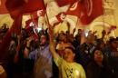 Demonstrators wave Tunisian flags during a protest against militants, on Avenue Habib Bourguiba in Tunis