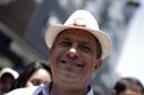 Luis Guillermo Solis, presidential candidate of the Citizens' Action Party, smiles during a walk in San Jose