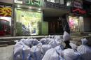 A man moves sandbags towards a shop as protection from future explosions at a stronghold of the Shi'ite group Hezbollah in the southern suburbs of Beirut