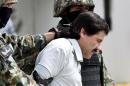 Mexican drug trafficker Joaquin Guzman Loera aka "el Chapo Guzman", is escorted by marines as he is presented to the press on February 22, 2014 in Mexico City