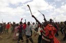 Supporters of Kenya's Deputy PM and presidential candidate Kenyatta from the Maasai community welcome him before a campaign rally in the Rift Valley town of Suswa