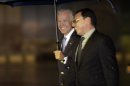 Vice President Joe Biden, holding an umbrella, walks with an unidentified Mexican official upon his arrival at the airport in Mexico City, Mexico, Thursday, Sept. 19, 2013. Biden will meet with Mexico's President Enrique Pena Nieto during his one-day visit. (AP Photo/Dario Lopez-Mills)