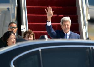 John Kerry waves as he arrives at Ngurah Rai Airport …