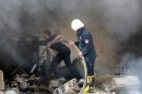 This photo released by the Syrian official news agency SANA shows Syrian firefighters extinguishing a fire in a damaged school after a bomb attack in Damascus, Syria, Tuesday, Sept. 25, 2012. Several bombs went off Tuesday inside a school in the Syrian capital that activists say was being used by regime forces as a security headquarters. Ambulances rushed to the area and an initial report on state media said several people were wounded. (AP Photo/SANA)