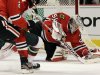 Chicago Blackhawks goalie Corey Crawford, right, saves a shot by Minnesota Wild's Charlie Coyle (not shown) during the first period of Game 2 of an NHL hockey Stanley Cup first-round playoff series in Chicago, Friday, May 3, 2013. (AP Photo/Nam Y. Huh)