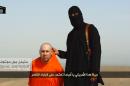 Still image from undated video of a masked Islamic State militant speaking next to man purported to be U.S. journalist Steven Sotloff at an unknown location