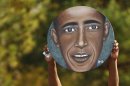 A supporter holds up an image of U.S. President Barack Obama at a campaign rally in Dayton