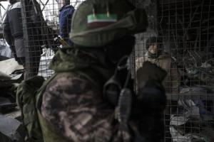 A Ukrainian war prisoner is guarded by armed men of &hellip;
