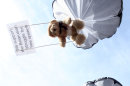 In this undated photo provided by Studio Total teddy bears hang on parachutes during a training in Stockholm, Sweden. Thomas Mazetti and Hannah Frey from Sweden intruded with a light plane on the Belarus' airspace and dropped hundreds of teddy bears carrying slogans supporting human rights and media freedom, on July 4, 2012. The two Swedes behind the stunt, said their idea was to show support for Belarusian human rights activists and to embarrass the country's military, which is a pillar of President Lukashenko's power. (AP Photo/Studio Total/Per Cromwell)