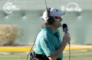 FILE - In this Feb. 4, 2012, file photo, golf announcer David Feherty broadcasts from the 16th green during the third round of the Phoenix Open golf tournament in Scottsdale, Ariz. Feherty has signed a contract with NBC Sports that will put him on the broadcast team with Johnny Miller, allow him to extend his popular "Feherty" series on Golf Channel and possibly lead to new ventures for golf's funnyman. Feherty had been with CBS Sports for nearly two decades and developed into one of golf's most famous on-course reporters with his mix of irreverence and Irish humor. (AP Photo/Ross D. Franklin, File)
