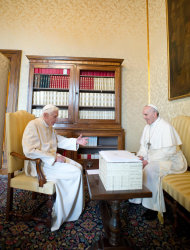 In this photo provided by the
 Vatican paper L'Osservatore Romano, Pope Francis, right, and Pope emeritus Benedict XVI meet in Castel Gandolfo Saturday, March 23, 2013. Pope Francis has traveled to Castel Gandolfo to have lunch with his predecessor Benedict XVI in a historic and potentially problematic melding of the papacies that has never before confronted the Catholic Church. The Vatican said the two popes embraced on the helipad. In the chapel where they prayed together, Benedict offered Francis the traditional kneeler used by the pope. Francis refused to take it alone, saying "We're brothers," and the two prayed together on the same one. (AP Photo/Osservatore Romano, HO)