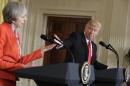 President Donald Trump gestures toward British Prime Minister Theresa May during their news conference in the East Room of the White House in Washington, Friday, Jan. 27, 2017. (AP Photo/Evan Vucci)