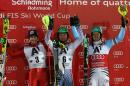 On the podium from left, Stefano Gross, of Italy, second placed, Alexander Khoroshilov, of Russia, winner, Felix Neureuther, of Germany, third placed, celebrate after a men's World Cup Slalom event, in Schladming, Austria, Tuesday, Jan. 27, 2015. (AP Photo/Giovanni Auletta)