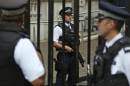 Armed police officers are seen on duty in Downing Street, central London