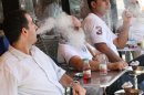 Lebanese men smoke at an outdoor cafe in Beirut