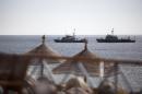 Egyptian navy vessels patrol off the coast of the Red Sea resort city of Sharm el-Sheikh on February 17, 2011