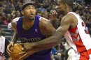 Sacramento Kings' Cousins drives to the basket past Toronto Raptors' Davis in the second half of their NBA basketball game in Toronto