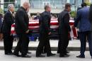 The casket containing Matthew Gerald is carried by pallbearers after a funeral service at Healing Place Church in Baton Rouge