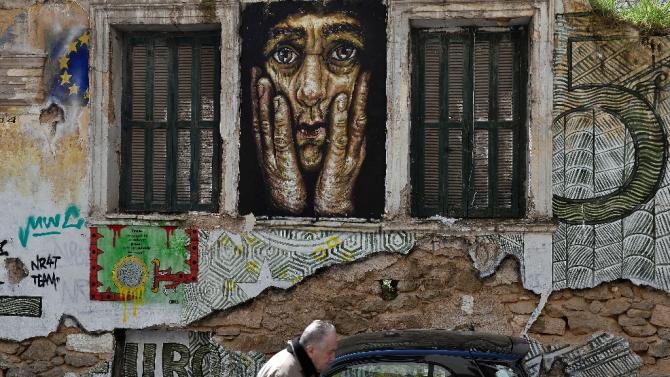 A derlict building adorned with graffiti and slogans reading 'Euro' in central Athens on March 19, 2015