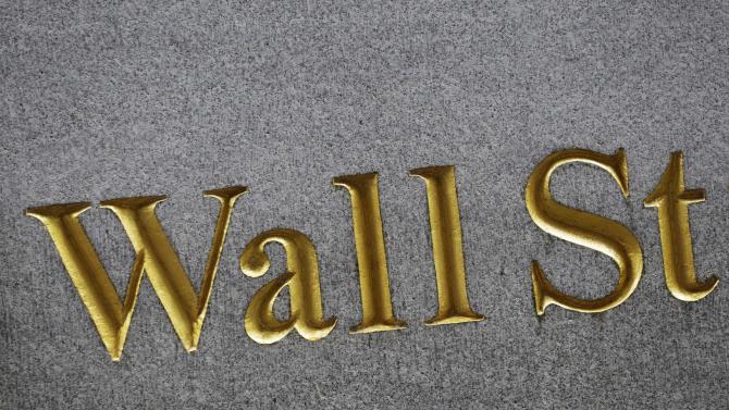 This Monday, July 6, 2015 photo shows a sign for Wall Street carved into the side of a building, in New York. Hopes that Greece will be able to forge a deal with creditors this weekend that will secure its euro future helped stock markets around the world and Europe&#39;s single currency itself post big gains on Friday, July 10. (AP Photo/Mark Lennihan)
