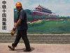 A worker walks outside a subway construction site, with boundary walls covered by photos of Tiananmen Gate, in Beijing, China, Wednesday, July 11, 2012. China's latest economic data point to a deepening slowdown that is adding to pressure on communist leaders to revive growth and avert job losses and political tensions. (AP Photo/Alexander F. Yuan)