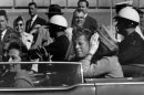 President John F. Kennedy rides in the motorcade in Dallas moments before his assassination on Nov. 22, 1963.