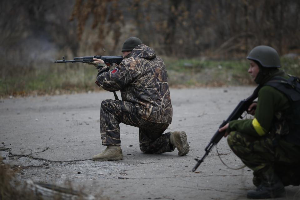 Ukrainian volunteer fighters shoot in the village of Peski near Donetsk, eastern Ukraine, Wednesday, Nov. 12, 2014. Fighting has continued in the east...