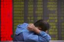 A Chinese investor monitors stock prices at a brokerage house in Beijing, Tuesday, Aug. 25, 2015. China's main stock market index has fallen for a fourth day, plunging 7.6 percent to an eight-month low. (AP Photo/Mark Schiefelbein)