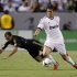 Real Madrid's Kaka takes ball away from Los Angeles Galaxy's Juninho during their World Football Challenge international friendly soccer match in Carson