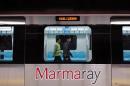 Two Japanese technicians walk inside a train for the inauguration of the tunnel called Marmaray in Istanbul, Turkey, Tuesday, Oct. 29, 2013. Turkey is for the first time connecting its European and Asian sides with a railway tunnel set to open Tuesday, completing a plan initially proposed by an Ottoman sultan about 150 years ago. The Marmaray, is among a number of large infrastructure projects under the government of Prime Minister Recep Tayyip Erdogan that have helped boost the economy but also have provoked a backlash of public protest.(AP Photo)