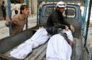 Bodies lie at the back of a truck after Syrian rescue workers pulled them out from the rubble reportedly following air strikes by government forces in the northern city of Aleppo on April 28, 2014