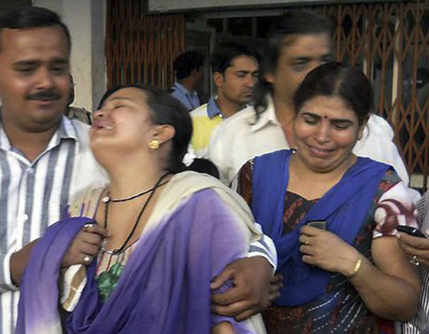 In this Saturday, May 25, 2013 photo, unidentified relatives of an injured of a rebel attack cry outside a government hospital in Raipur, India. About 200 suspected Maoist rebels set off a land mine and opened fire on a convoy of cars carrying local leaders and supporters of India's ruling Congress party in the country's east, killing at least 28 people and wounding 24 others, police said. (AP Photo)