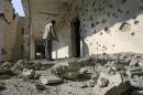 A man inspects the site of a mortar attack in the city of Falluja