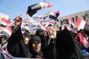 Iraqi women, supporters of Shiite cleric Moqtada al-Sadr, take part in a protest outside Baghdad's fortified Green Zone on March, 30, 2016