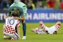 Portugal's Pepe consoles Croatia's Luka Modric at the end of the Euro 2016 round of 16 soccer match between Croatia and Portugal at the Bollaert stadium in Lens, France, Saturday, June 25, 2016. (AP Photo/ Michel Spingler)