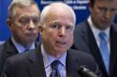 U.S. Sen. John McCain, R-Ariz., center, speaks during a news conference in Kiev, Ukraine, Saturday, March 15, 2014. McCain and a team of seven other senators concluded their visit in Kiev on Saturday with a news conference in which they reaffirmed their support to the interim Ukrainian government. (AP Photo/David Azia)